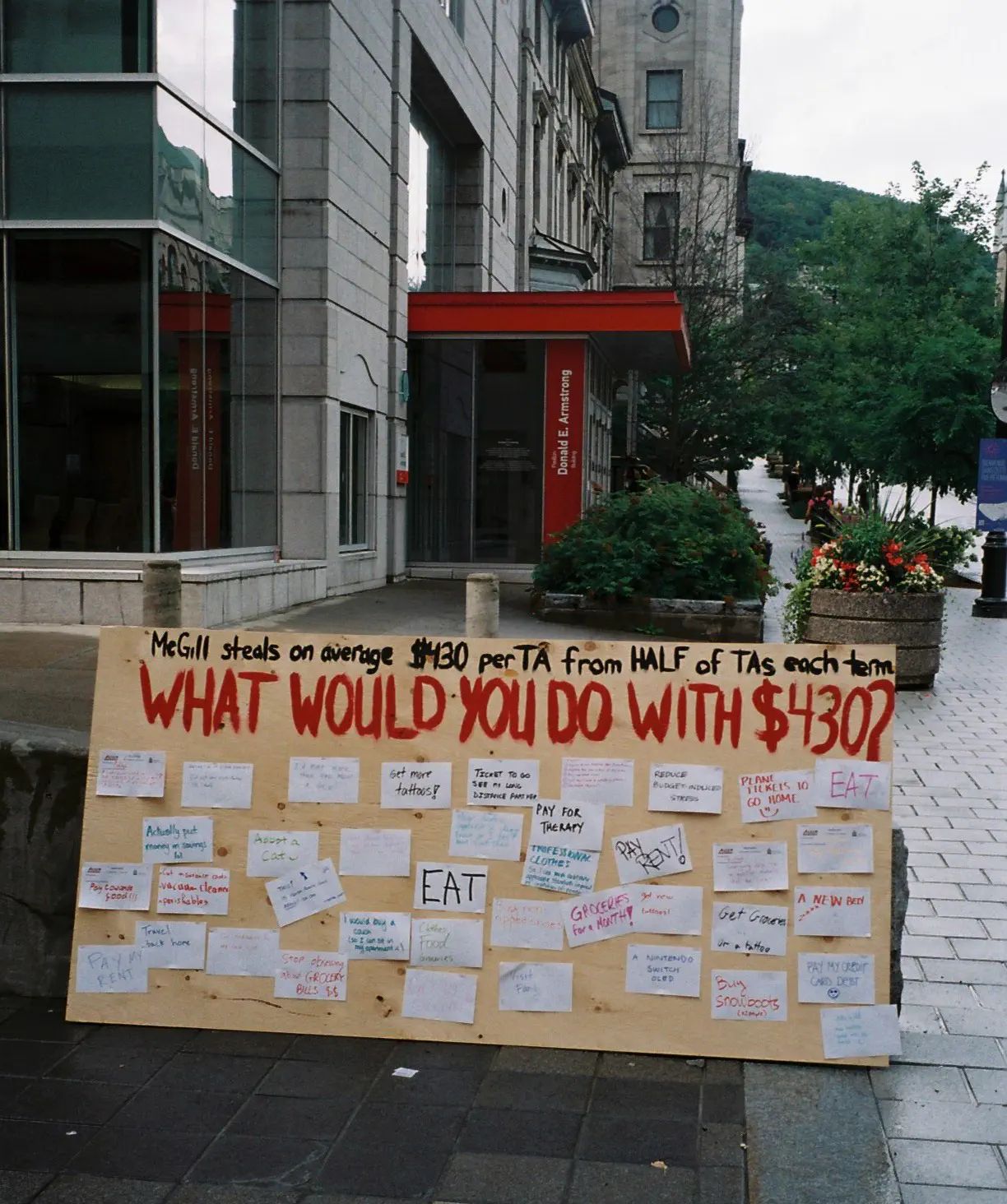 Photo of “What would you do with $430?” board where AGSEM members shared how they would spend $430, including buying groceries, paying rent, paying off debt, paying for therapy, adopting a pet, visiting family, and getting more tattoos at the “First Day of School: Let’s Work to Rule” rally (August 30, 2023).